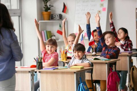 School children. Hands up. Paul Claireaux